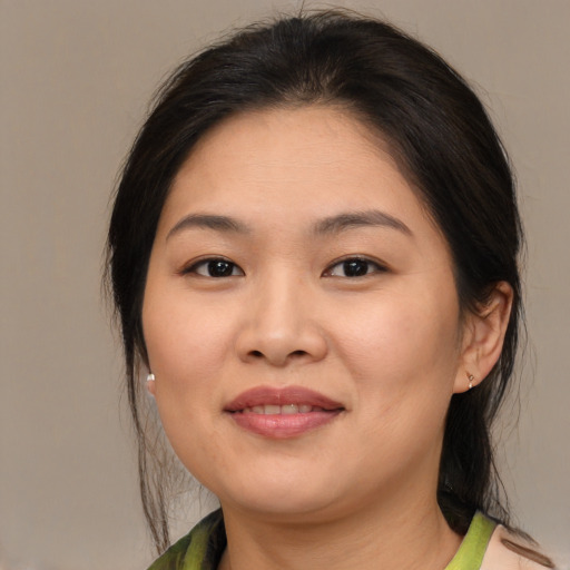 Joyful white young-adult female with medium  brown hair and brown eyes