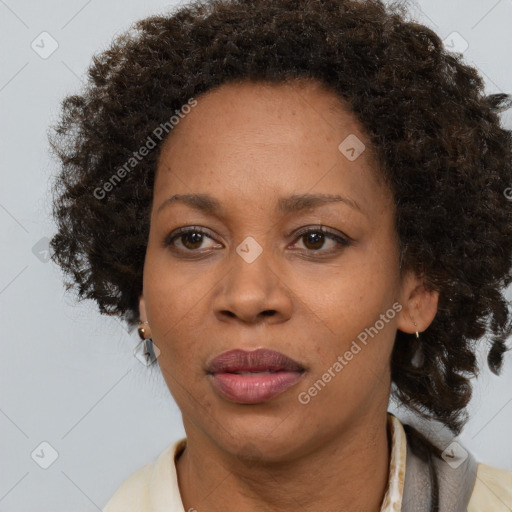 Joyful black adult female with medium  brown hair and brown eyes