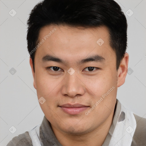 Joyful asian young-adult male with short  brown hair and brown eyes