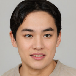 Joyful asian young-adult male with short  brown hair and brown eyes