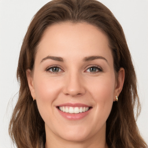 Joyful white young-adult female with long  brown hair and grey eyes