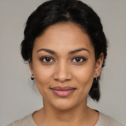 Joyful latino young-adult female with medium  black hair and brown eyes