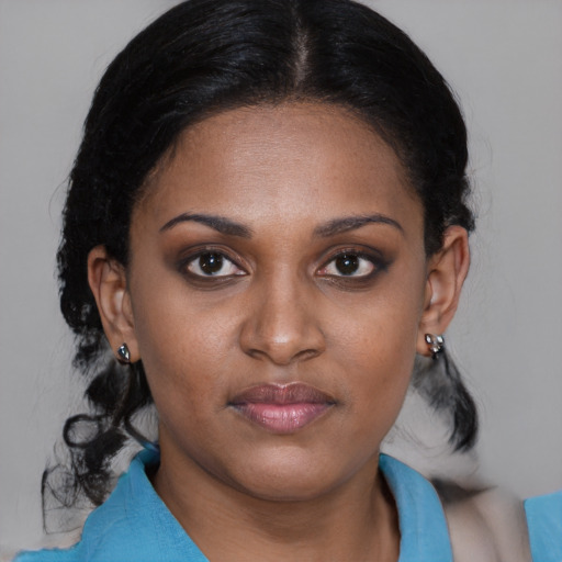 Joyful black young-adult female with medium  brown hair and brown eyes