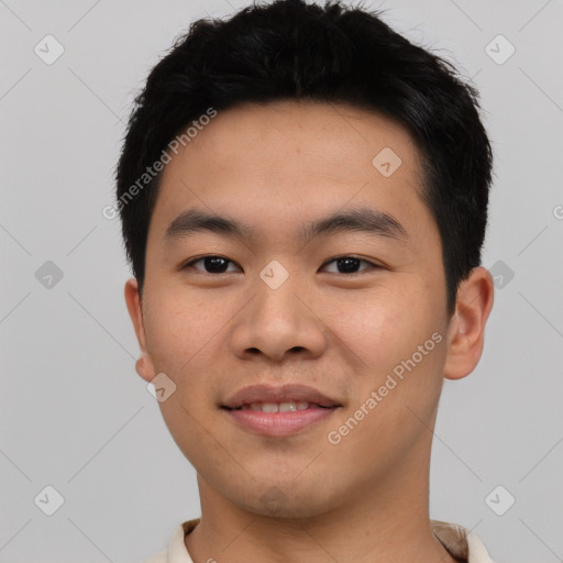 Joyful asian young-adult male with short  brown hair and brown eyes