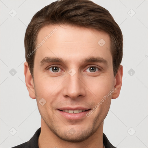 Joyful white young-adult male with short  brown hair and grey eyes