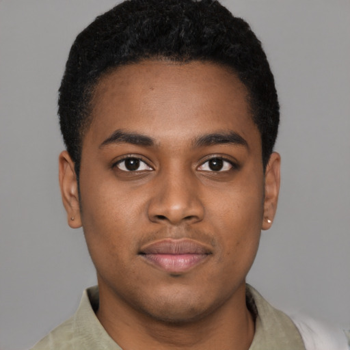 Joyful black young-adult male with short  brown hair and brown eyes