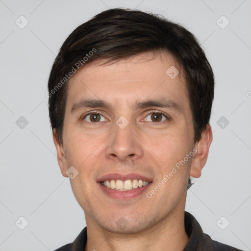 Joyful white young-adult male with short  brown hair and grey eyes