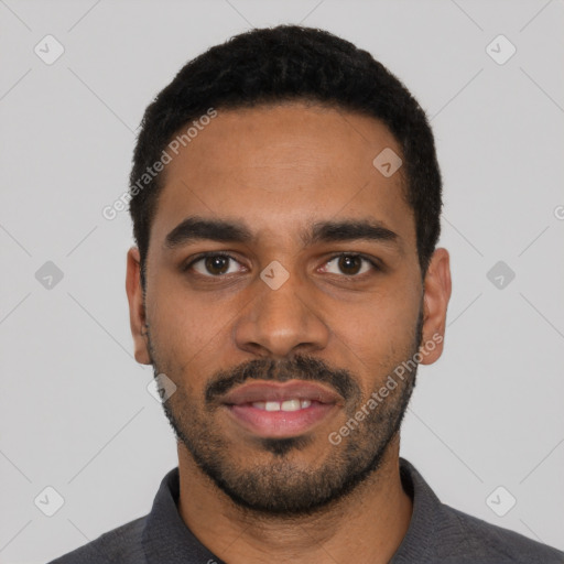 Joyful black young-adult male with short  black hair and brown eyes