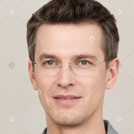 Joyful white adult male with short  brown hair and grey eyes