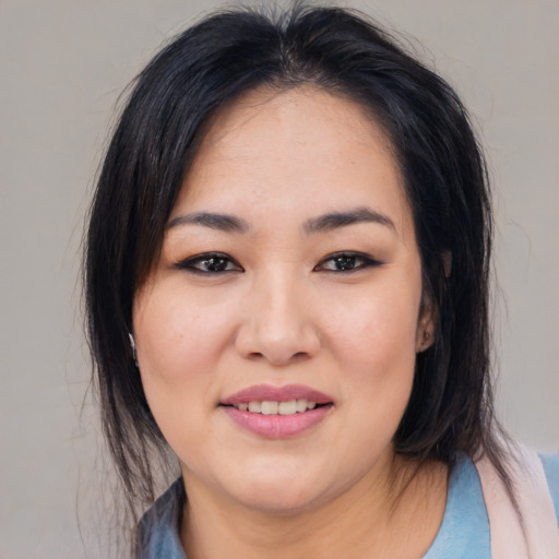 Joyful asian young-adult female with medium  black hair and brown eyes