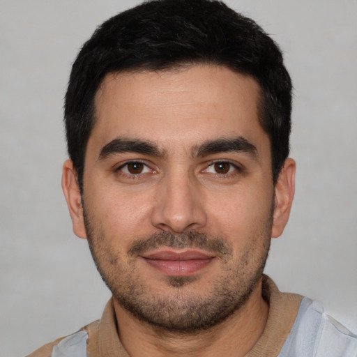 Joyful white young-adult male with short  black hair and brown eyes