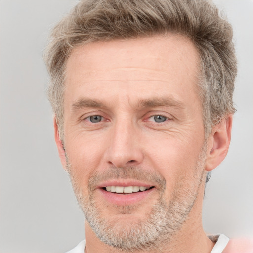 Joyful white adult male with short  brown hair and grey eyes