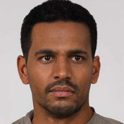 Neutral latino young-adult male with short  black hair and brown eyes