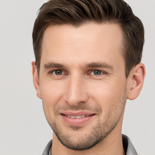 Joyful white young-adult male with short  brown hair and brown eyes