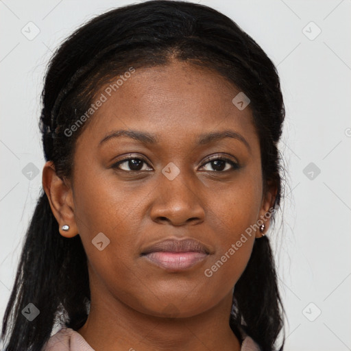 Joyful black young-adult female with long  brown hair and brown eyes