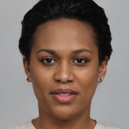 Joyful black young-adult female with short  black hair and brown eyes