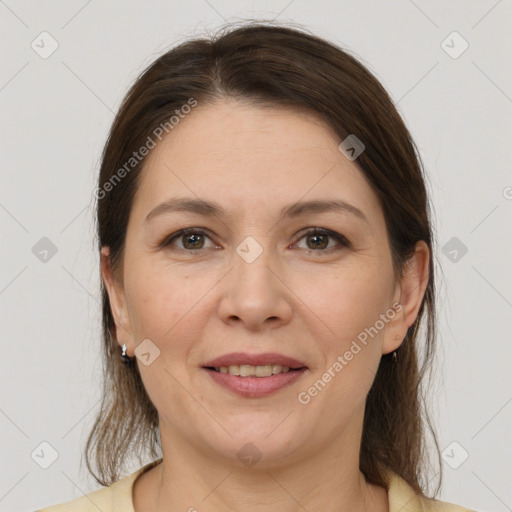 Joyful white adult female with medium  brown hair and grey eyes