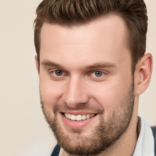 Joyful white young-adult male with short  brown hair and brown eyes