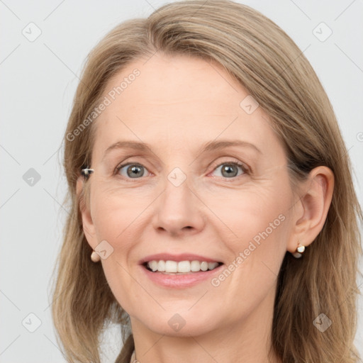 Joyful white adult female with medium  brown hair and grey eyes