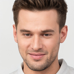 Joyful white young-adult male with short  brown hair and brown eyes