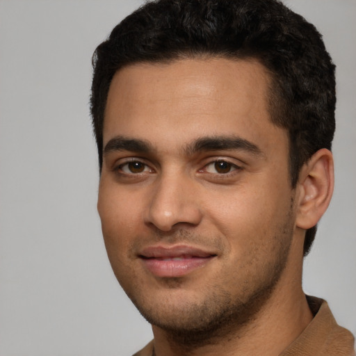 Joyful white young-adult male with short  black hair and brown eyes