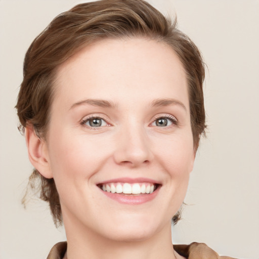 Joyful white young-adult female with medium  brown hair and grey eyes