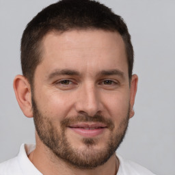 Joyful white adult male with short  brown hair and brown eyes