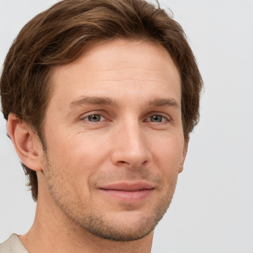 Joyful white adult male with short  brown hair and grey eyes