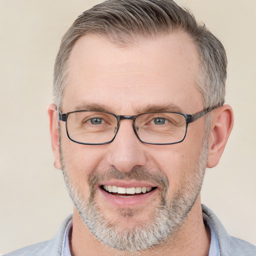 Joyful white adult male with short  gray hair and brown eyes