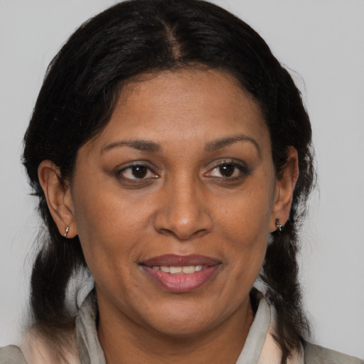 Joyful black adult female with medium  brown hair and brown eyes