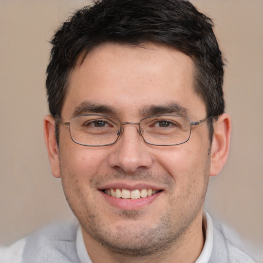 Joyful white adult male with short  brown hair and brown eyes