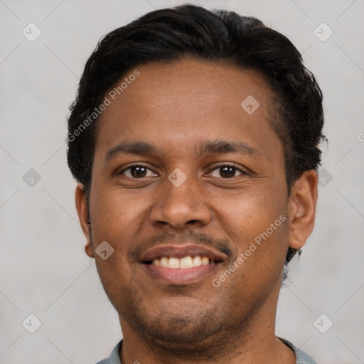 Joyful black young-adult male with short  brown hair and brown eyes