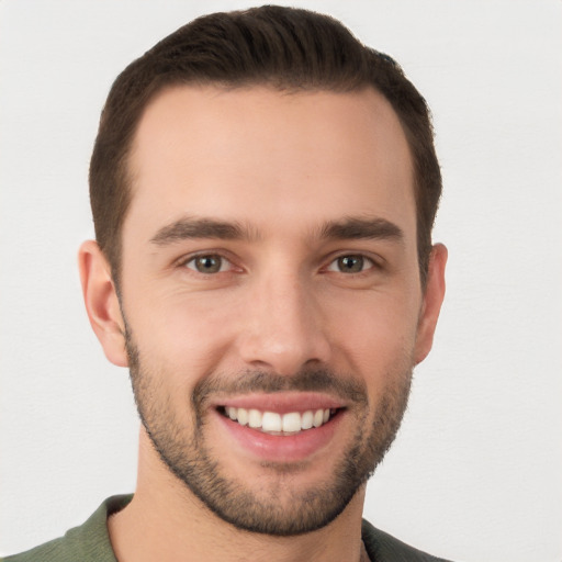 Joyful white young-adult male with short  brown hair and brown eyes