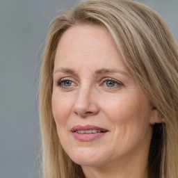 Joyful white adult female with long  brown hair and brown eyes