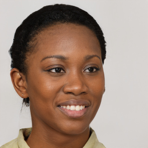 Joyful black young-adult female with short  brown hair and brown eyes