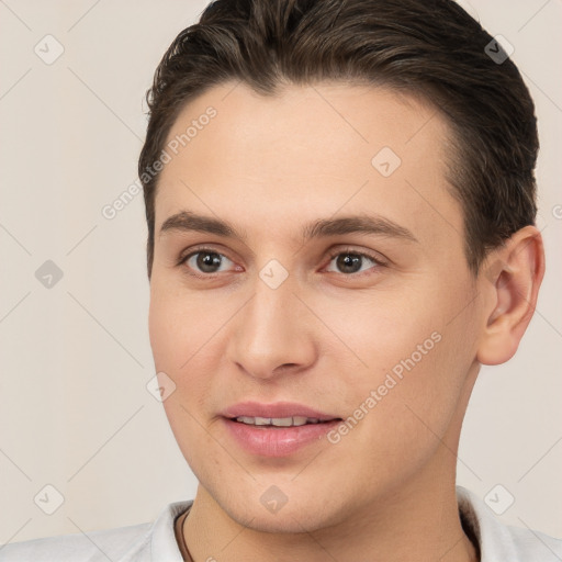 Joyful white young-adult male with short  brown hair and brown eyes