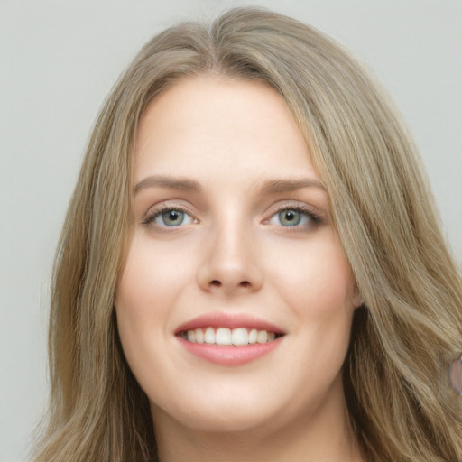 Joyful white young-adult female with long  brown hair and blue eyes