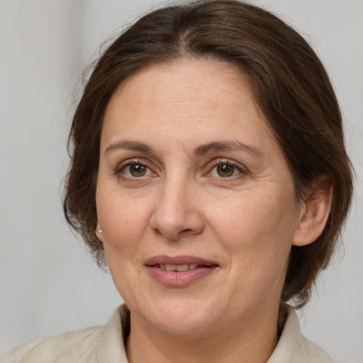 Joyful white adult female with medium  brown hair and brown eyes