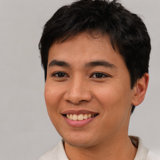 Joyful asian young-adult male with short  brown hair and brown eyes