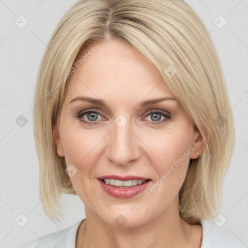 Joyful white adult female with medium  brown hair and blue eyes