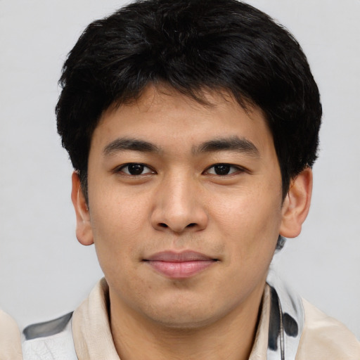 Joyful asian young-adult male with short  brown hair and brown eyes