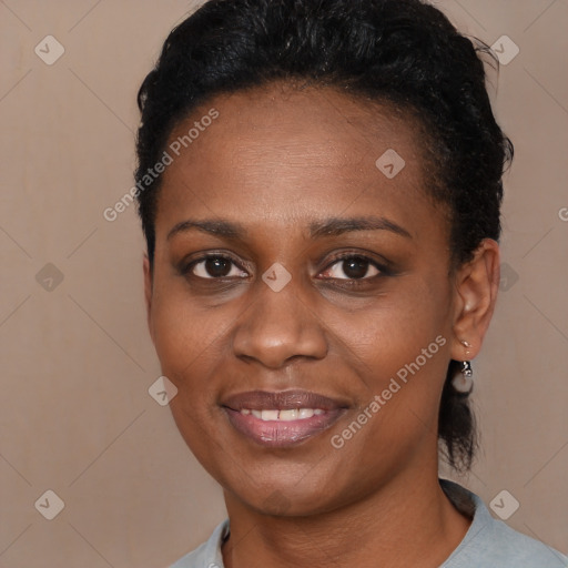 Joyful black young-adult female with short  black hair and brown eyes