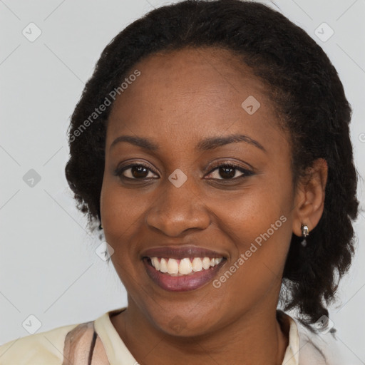 Joyful black young-adult female with long  brown hair and brown eyes