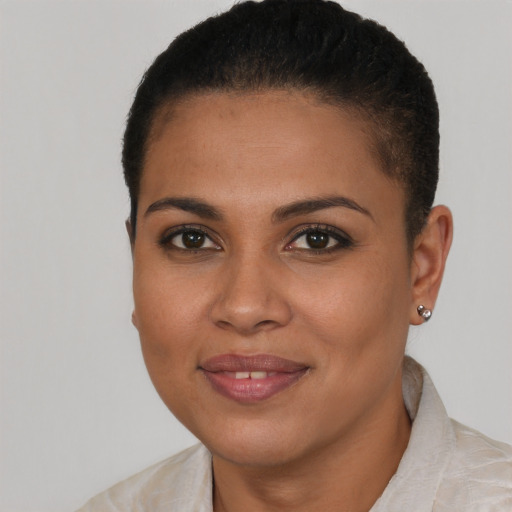 Joyful black young-adult female with short  brown hair and brown eyes