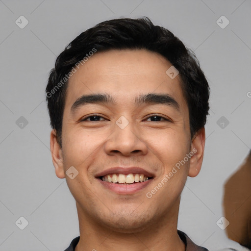 Joyful white young-adult male with short  black hair and brown eyes