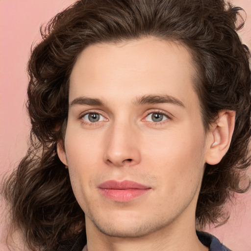 Joyful white young-adult male with medium  brown hair and brown eyes