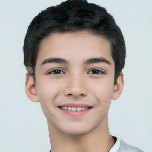 Joyful white child male with short  black hair and brown eyes