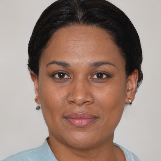Joyful black adult female with short  brown hair and brown eyes