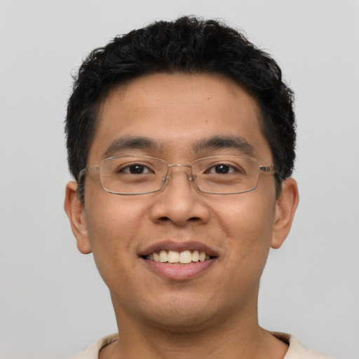 Joyful asian young-adult male with short  black hair and brown eyes