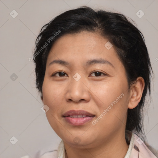 Joyful asian adult female with medium  brown hair and brown eyes